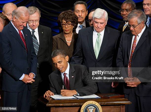 President Barack Obama signs the Dodd-Frank Wall Street Reform and Consumer Protection financial overhaul bill at the Ronald Reagan Building in...