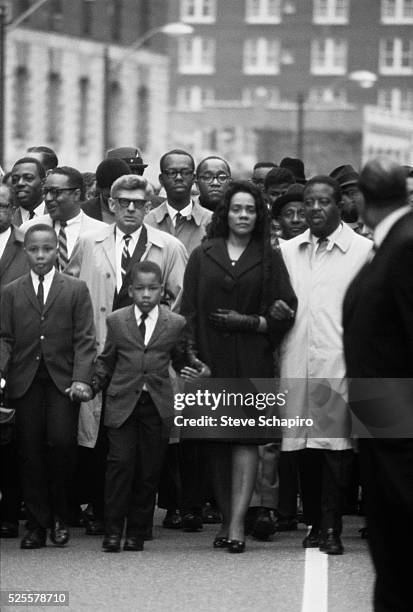 Coretta Scott King, along with her sons and Reverend Abernathy, walk through the streets of Memphis after the assassination of her husband, civil...