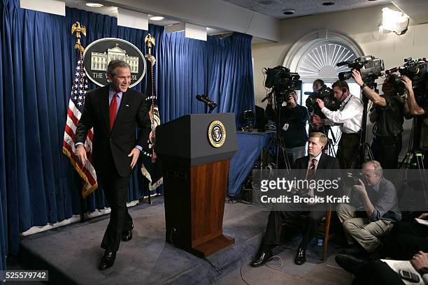 President George W Bush, left, leaves a news conference, on March 16 in the Brady Press Briefing Room at the White House.
