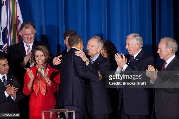 President Barack Obama hugs Senate Majority Leader Harry Reid before signing the Don't Ask, Don't Tell Repeal Act of 2010 into law at the U.S....