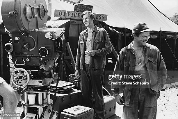 Alan Alda and Gary Burghoff on the set of the TV show 'MASH', which aired from 1972-1983.