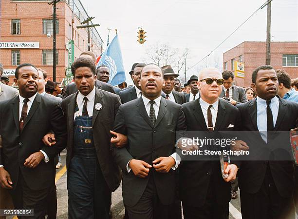 Martin Luther King Jr leading a march from Selma to Montgomery to protest the lack of voting rights for African Americans. Beside King is John Lewis,...