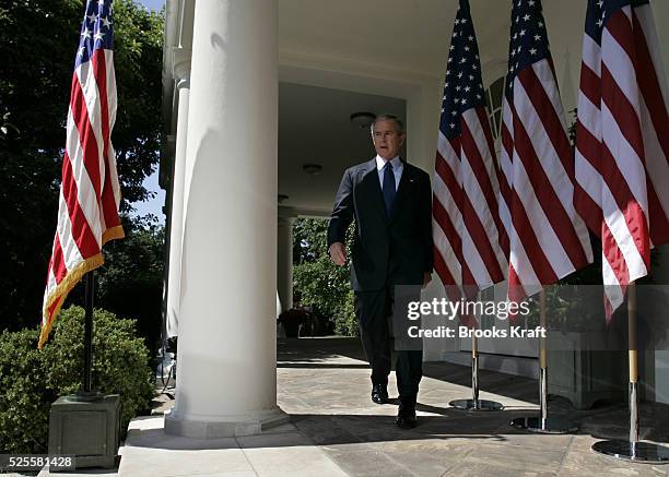 President George W. Bush walks from the Oval Office to a press conference in the Rose Garden at the White House. Bush spoke on a variety of issues...