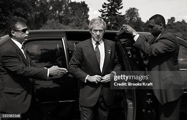 President George W. Bush, center, gets out of his limousine surrounded by secret service agents, as departs the G8 Summit at Gleneagles Scotland...