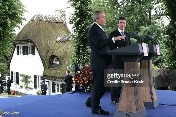 President George W. Bush, left, and Danish Prime Minister Anders Fogh Rasmussen speak to reporters during a joint press conference at Marienborg,...