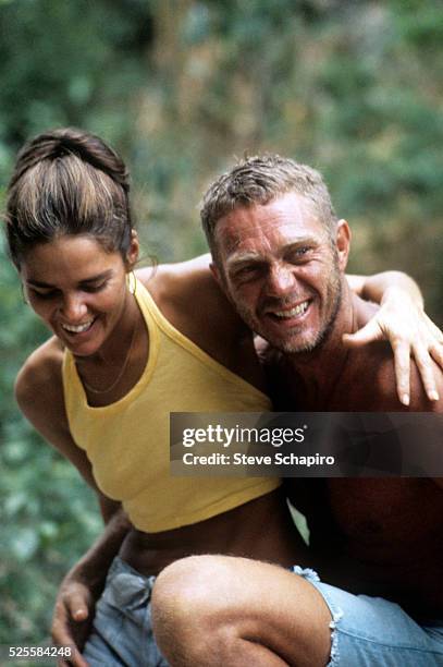 Actress Ali MacGraw and actor Steve McQueen on a break during the filming of Papillon, in which McQueen stars, on location in Jamaica.