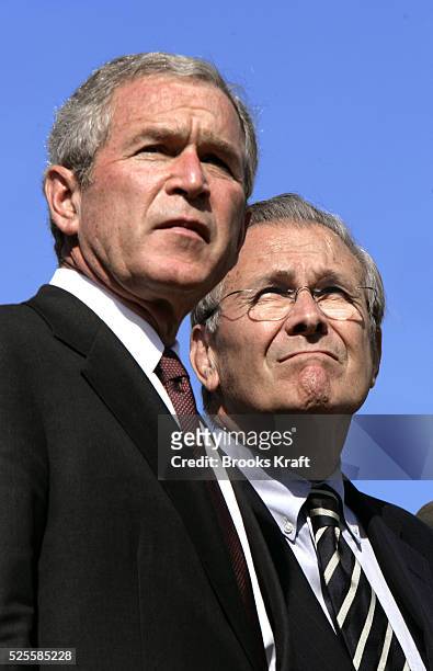 President Bush, left, and Secretary of Defense Donald Rumsfeld watch a flyover during an Armed Forces farewell tribute in honor of Chairman of the...