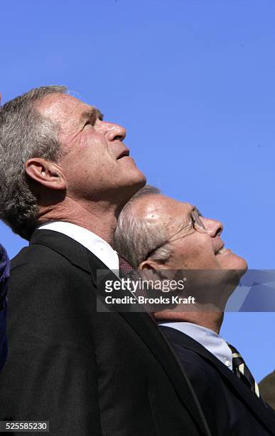President George W. Bush, left, and Secretary of Defense Donald Rumsfeld watch U.S. Air Force jets fly over Summerall Field during an Armed Forces...