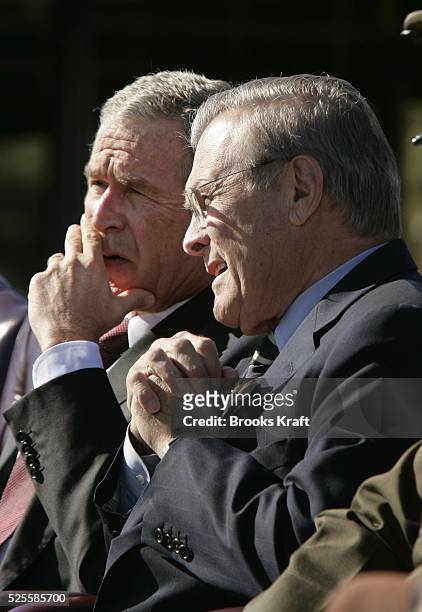 President George W. Bush, left, and Secretary of Defense Donald Rumsfeld watch a flyover during an Armed Forces farewell tribute in honor of Chairman...