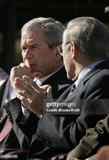 President George W. Bush, left, and Secretary of Defense Donald Rumsfeld watch a flyover during an Armed Forces farewell tribute in honor of Chairman...