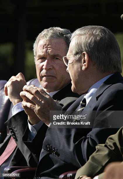 President George W. Bush, left, and Secretary of Defense Donald Rumsfeld watch a flyover during an Armed Forces farewell tribute in honor of Chairman...