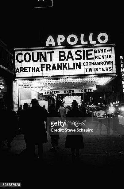 Apollo Theater marquee with Count Basie Band and Revue, singer Aretha Franklin, Cook & Brown, and the Twisters listed on the sign, New York, 1962.