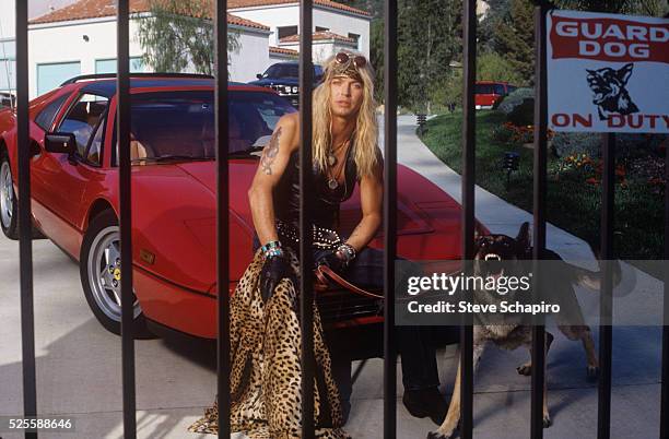 Musician Bret Michaels behind gate with guard dog