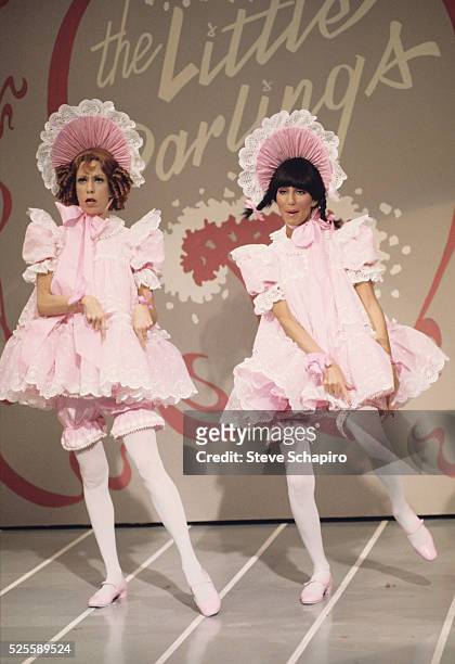 Carol Burnett and Cher dancing in babydoll costumes