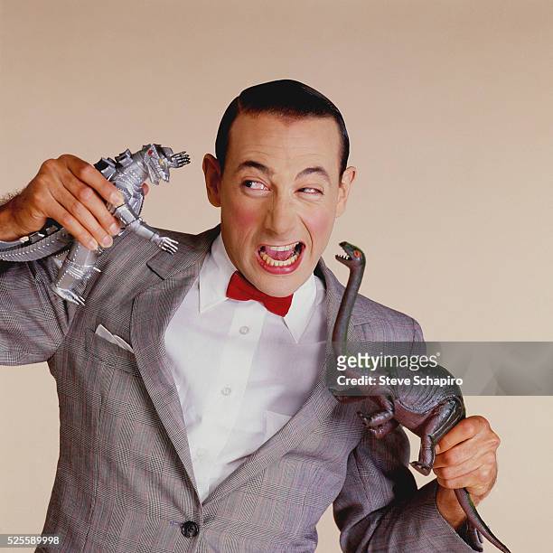 Pee-wee Herman playing with toys