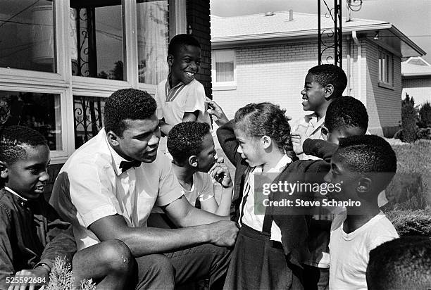Muhammad Ali with neighborhood kids in Louisville, including Yolanda "Lonnie" Williams who would become his wife in 1986.