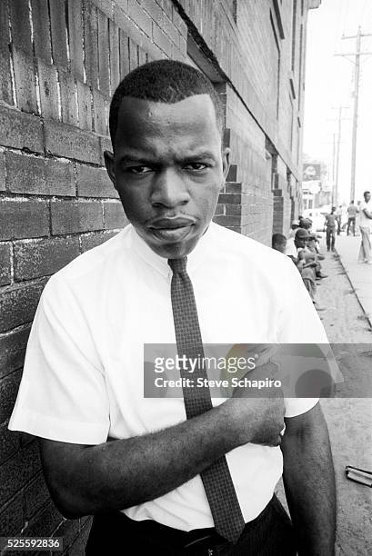 Portrait of Student Nonviolent Coordinating Committee chairman and Civil Rights activist John Lewis as he leans against a brick wall, Clarksdale,...