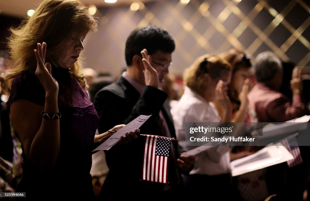 Naturalization Rights Citizens from around the world hold up their right hands as they ...