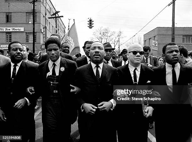 Martin Luther King, Jr. Leading the march from Selma to Montgomery to protest the lack of voting rights for African Americans. Beside King are John...