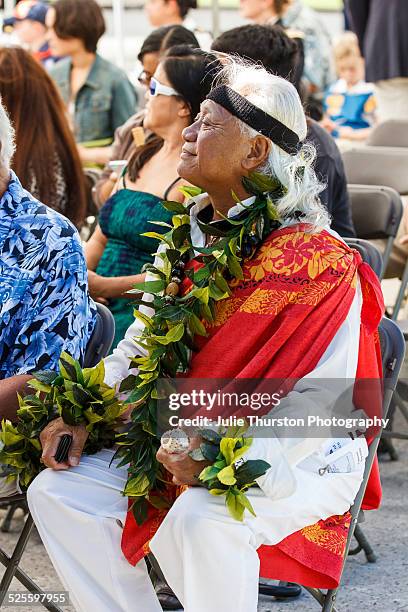 Hawaiian Man Gives a Conch Horn Blessing in an American Flag and Lei Filled Patriotic Veteran's Day Ceremony at the Hawaii Veteran's Cemetery in...