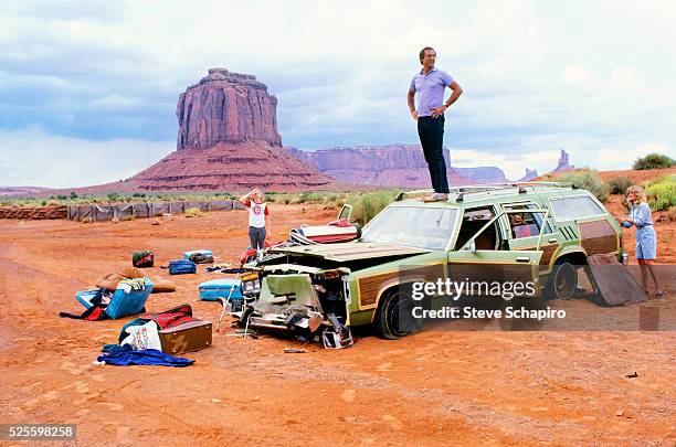American actor Anthony Michael Hall as Rusty Griswold, with American actor and comedian Chevy Chase as Clark W. Griswold standing on top of a Wagon...