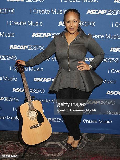 Musician Erica Campbell poses with a #StandWithSongwriters guitar, which will be presented in May to members of Congress to urge them to support...