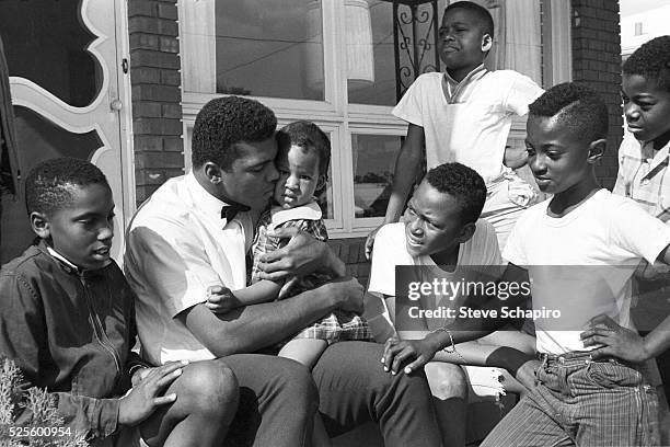 Muhammad Ali with neighborhood kids outside his mother's house in Louisville, Kentucky