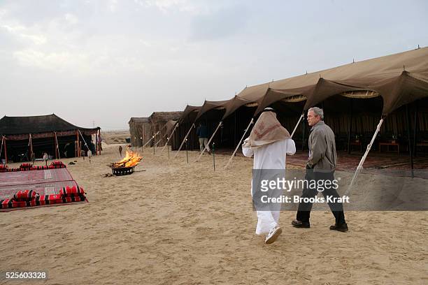 President George W. Bush is welcomed by Abu Dhabi Crown Prince Sheikh Mohammed Bin Zayed Al Nahyan to his desert encampment near Sowaihan in the...