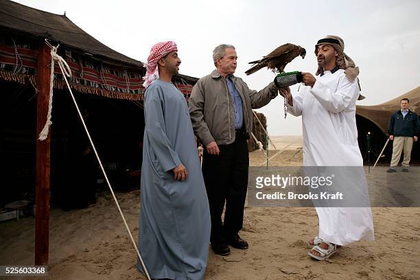 President George W. Bush is shown a falcon owned by Crown Prince of the Emirate of Abu Dhabi Sheikh Mohammed Bin Zayed al-Nahayan , in the desert...
