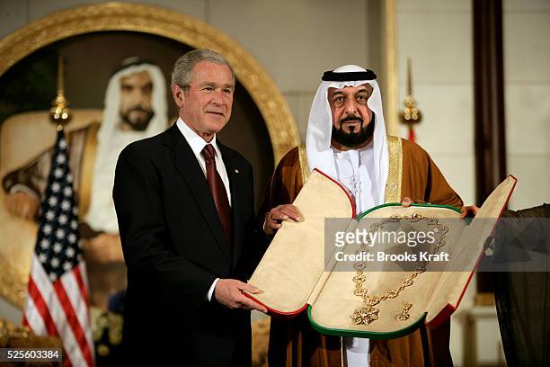 President George W. Bush receives a gift from United Arab Emirates' President Sheikh Khalifa bin Zayed al-Nahayan at Al Mushref Palace in Abu Dhabi....