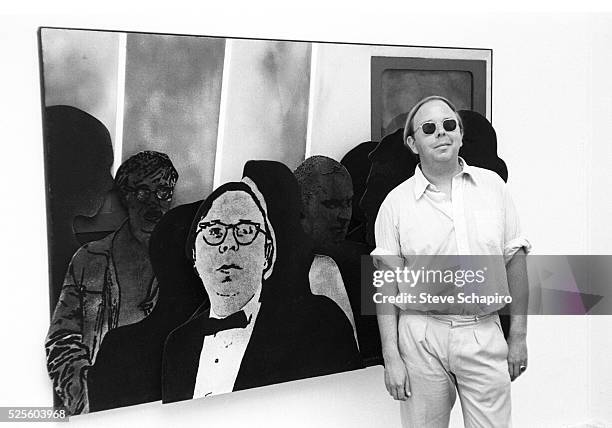 Henry Geldzahler stands in front of a painting by an unknown artist featuring an image of himself and Andy Warhol at the Venice Biennale in 1966