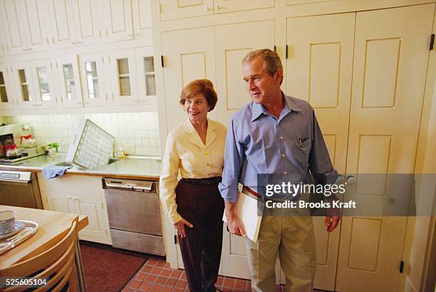 George W. Bush and his wife Laura stand in the kitchen of the Governor's Mansion in Austin, Texas. Governor of Texas since 1994, Bush was granted the...