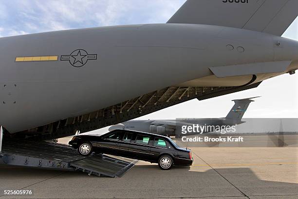 Presidential limousine is loaded onto a C5 military transport plane bound for eastern Europe, where President Bush is headed next week. A "secure...