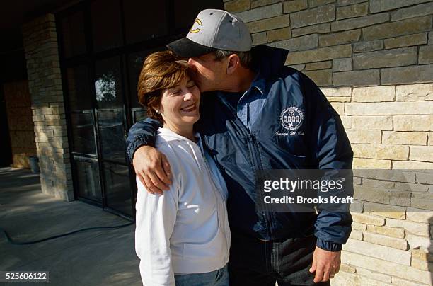 George W. Bush hugs his wife Laura at their ranch in Texas while awaiting the results of the 2000 Presidential Election recount. The controversial...
