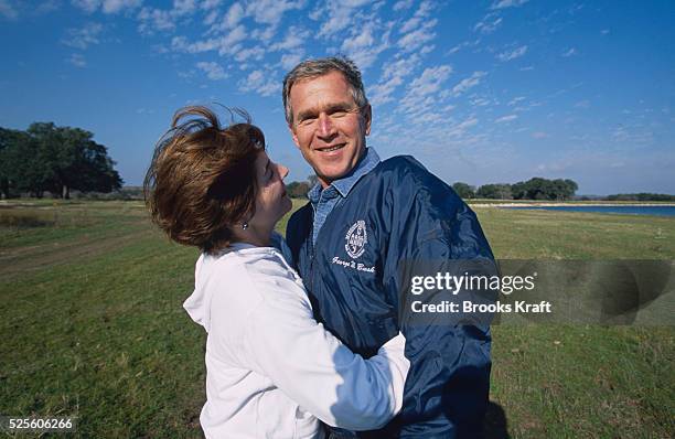 George W. Bush and his wife Laura share a hug at their Texas ranch while awaiting the results of the 2000 Presidential Election recount. The...