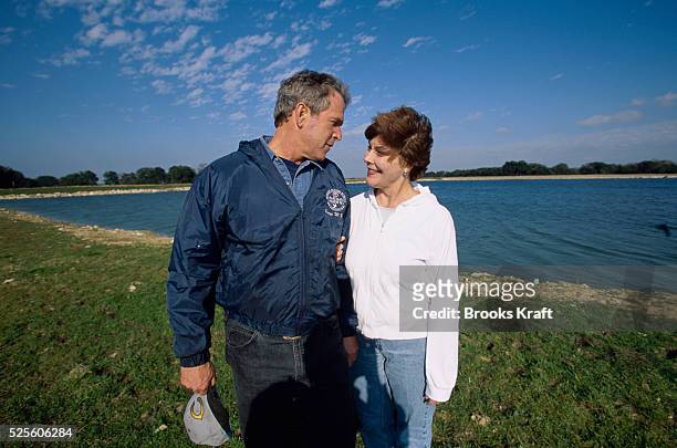 George W. Bush and his wife Laura take a stroll on their Texas ranch while awaiting the results of the 2000 Presidential Election recount. The...