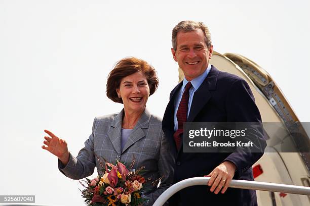 George W. Bush and his wife Laura arrive in Cedar Rapids, Iowa, during the presidential campaign. Bush won the 2000 Presidential Election against...