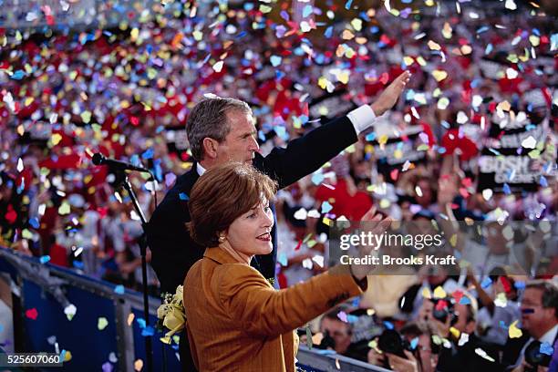 George W. Bush and his wife Laura wave to supporters at at a presidential campaign rally in Dearborn, Michigan. Bush won the 2000 Presidential...