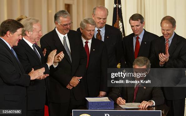 Signing Rfs W. Bush President George Bush signs a document at the White House. Present ...