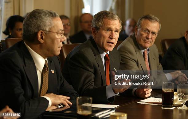 President George W. Bush meets with his cabinet at the White House, including Secretary of State Colin Powell and Secretary of Defense Donald...