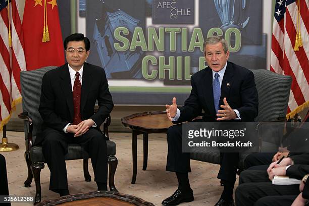 President George W. Bush with Chinese President Hu Jintao at their bilateral meeting in Santiago, November 20, 2004 during the annual Asia Pacific...