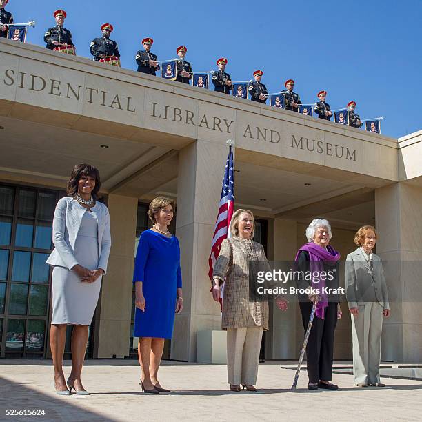 First Lady Michelle Obama poses with former first ladies Laura Bush, Hillary Clinton, Barbara Bush and Rosalynn Carter as they attend the dedication...