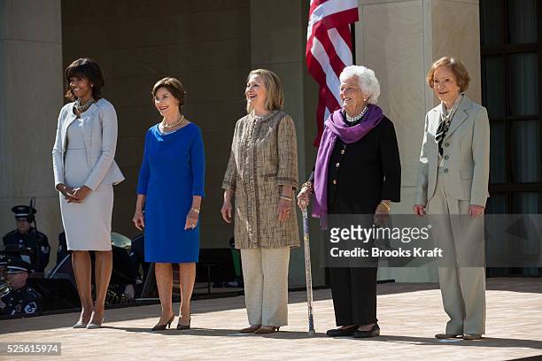 First Lady Michelle Obama poses with former first ladies Laura Bush, Hillary Clinton, Barbara Bush and Rosalynn Carter as they attend the dedication...