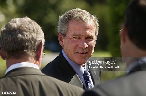 United States President George W. Bush greets lawmakers after pushing his administration's "Clear Skies" Initiative, a plan for reducing harmful...