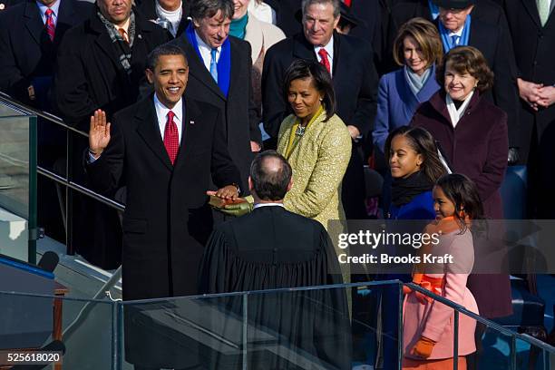 The 44th President of the United States, Barack Obama, takes the oath given by US. Supreme Chief Justice John Roberts, Jr. During the inauguration...