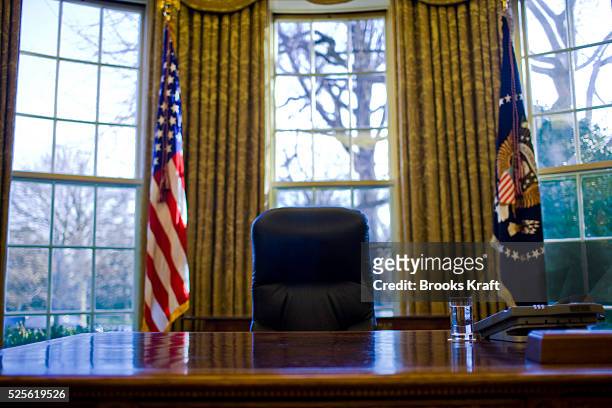 Glass of water sits on President Barack Obama's desk in the Oval Office at the White House in Washington.