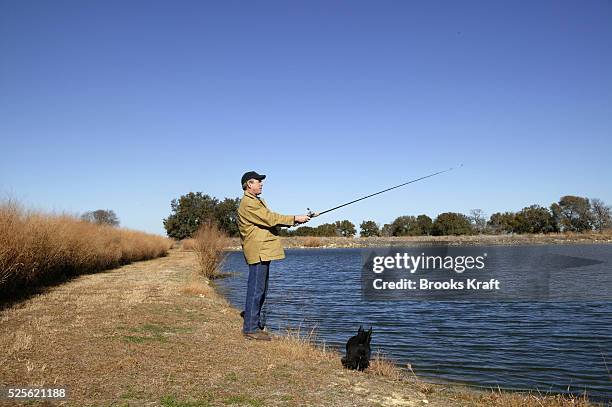 President George W. Bush goes fishing with his dog Barney at the lake on the Bush ranch in Crawford, Texas on December 29, 2003.