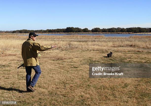 President George W. Bush goes fishing with his dog Barney at the lake on the Bush ranch in Crawford, Texas.