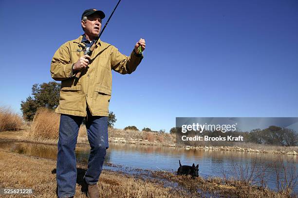 President George W. Bush goes fishing with his dog Barney at the lake on the Bush ranch in Crawford, Texas.