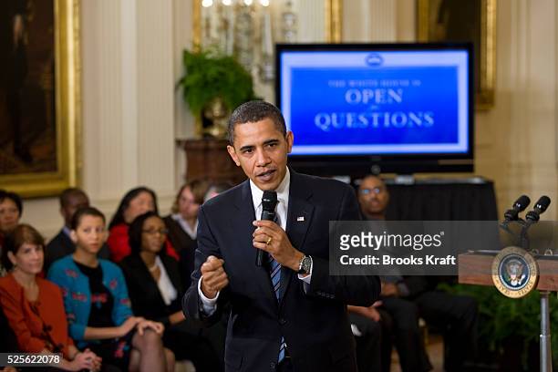 President Barack Obama takes part in an Internet online virtual town hall meeting in the East Room of the White House in Washington.